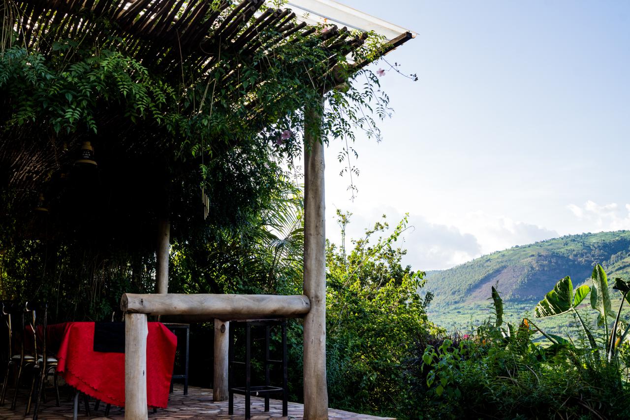 Shaded patio with wooden structure overlooking the valley