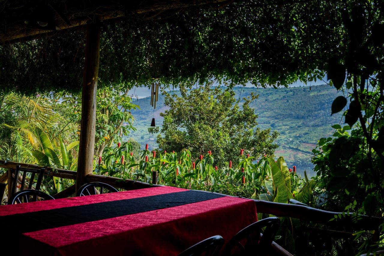 Covered terrace dining table with a view over Lake Muhazi