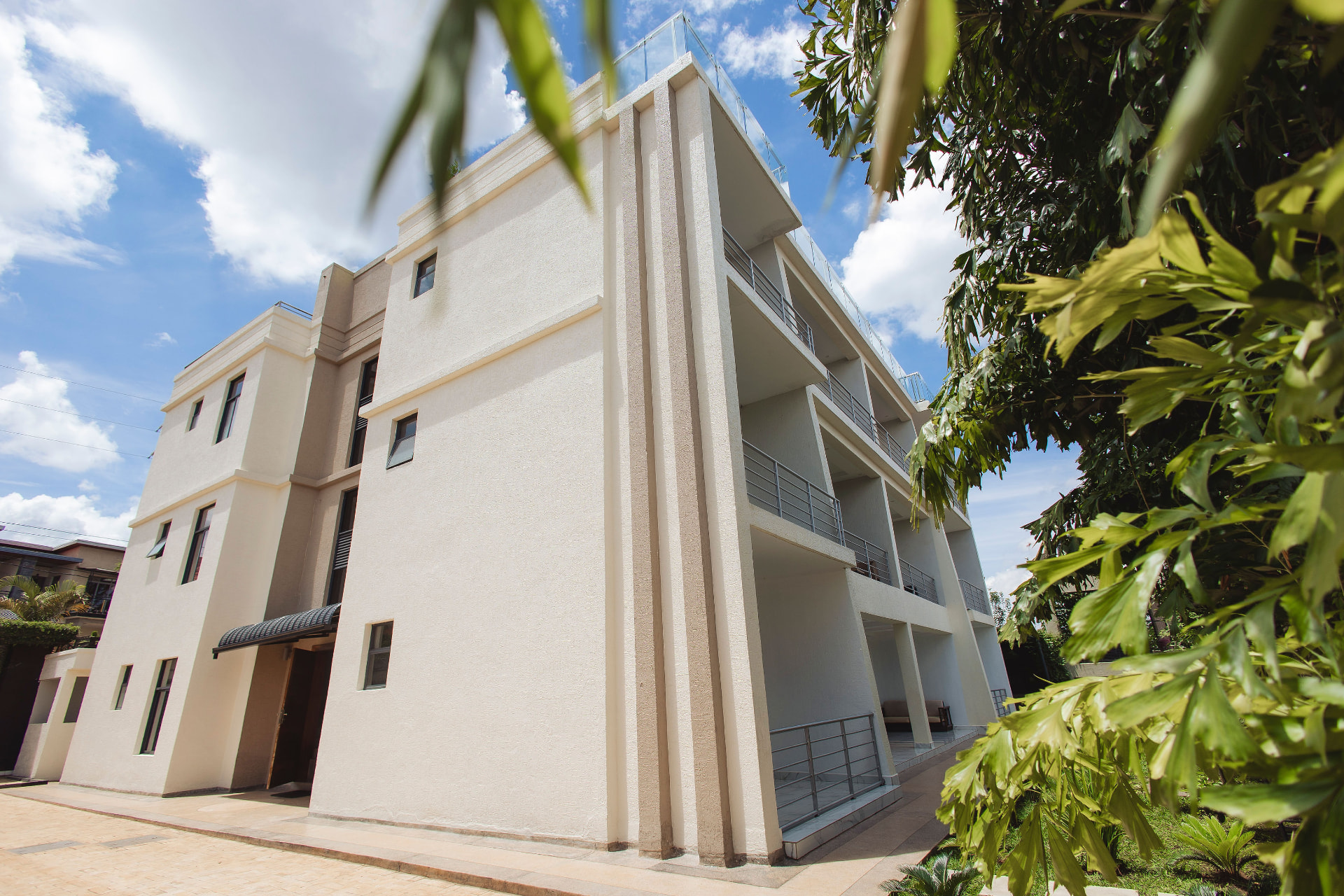 ISUITE Apartments exterior with balconies under a blue sky