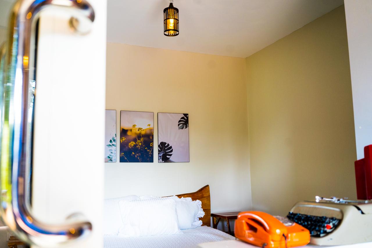 Bedroom detail with vintage orange telephone